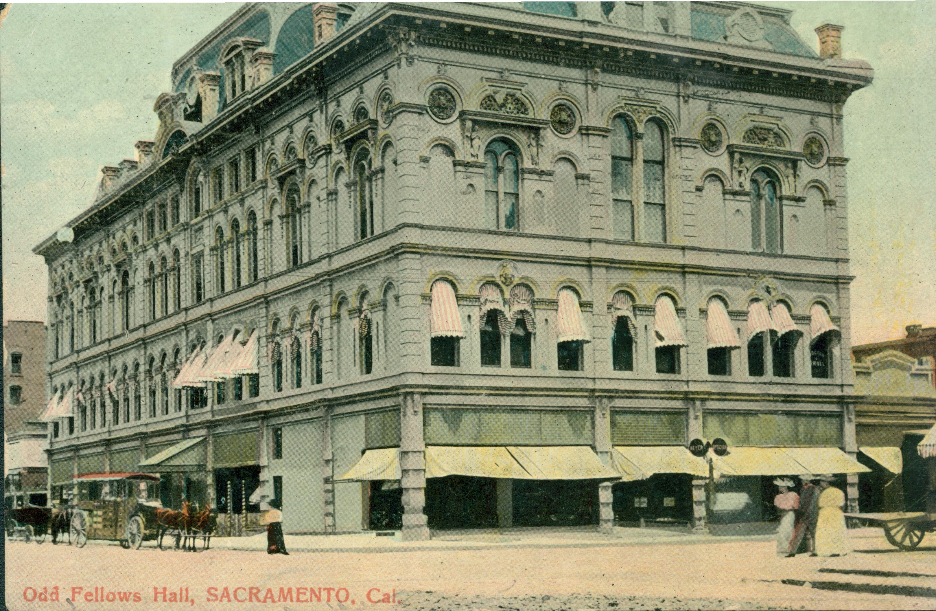 This postcard shows a corner view of the Odd Fellows Hall in Sacramento.